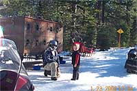 Wow! We're back at the park lot -- there is Pat with Dogsled Express -- we must stop and pet more dogs! Cameron loves dogs! 